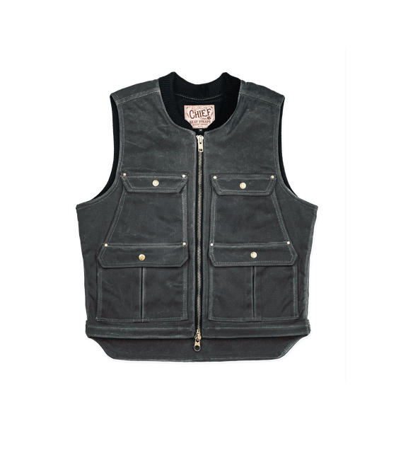 A charcoal waxed canvas utility vest with brass zip and flap pockets