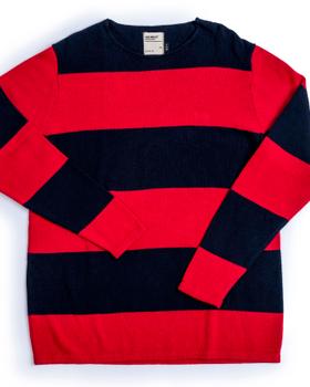 A navy and red block-striped Heimat virgin-wool crewneck sweater laid flat on a white background