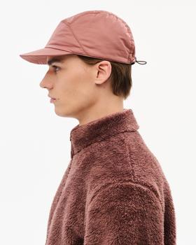 A man wearing a dusty pink Hiking Patrol nylon cap and matching fleece jacket
