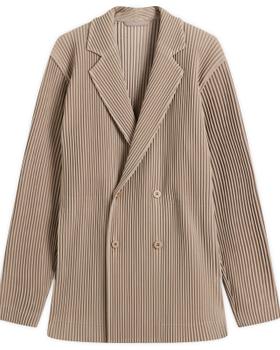 A taupe HOMME PLISSÉ ISSEY MIYAKE pleated double-breasted blazer on a plain background