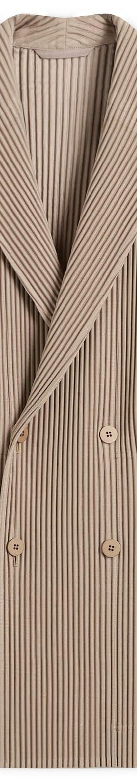 A taupe HOMME PLISSÉ ISSEY MIYAKE pleated double-breasted blazer on a plain background