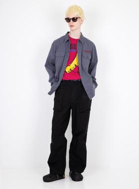 A man in sunglasses wearing a grey Hysteric Glamour work shirt over a pink graphic tee