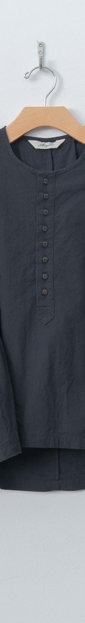 A charcoal Ichi Antiquités linen blouse with flared sleeves and gathered peplum hem, hung against a pale wall