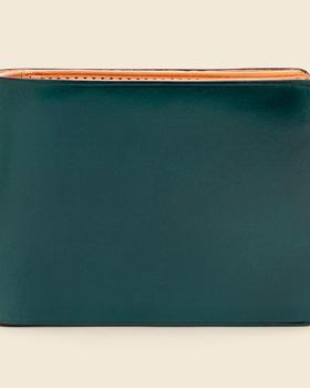 A dark green Il Bussetto hand-dyed leather bifold wallet with natural tan interior