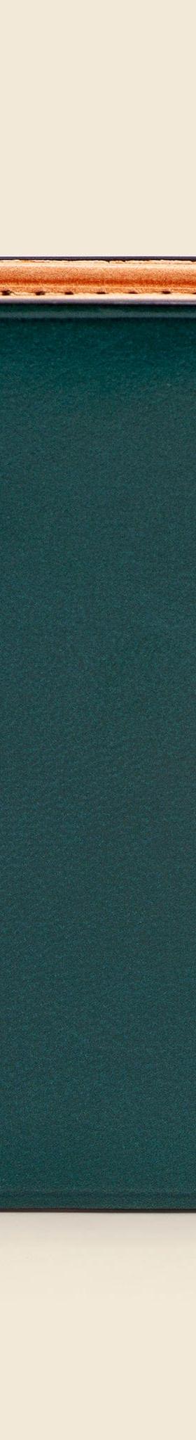 A dark green Il Bussetto hand-dyed leather bifold wallet with natural tan interior