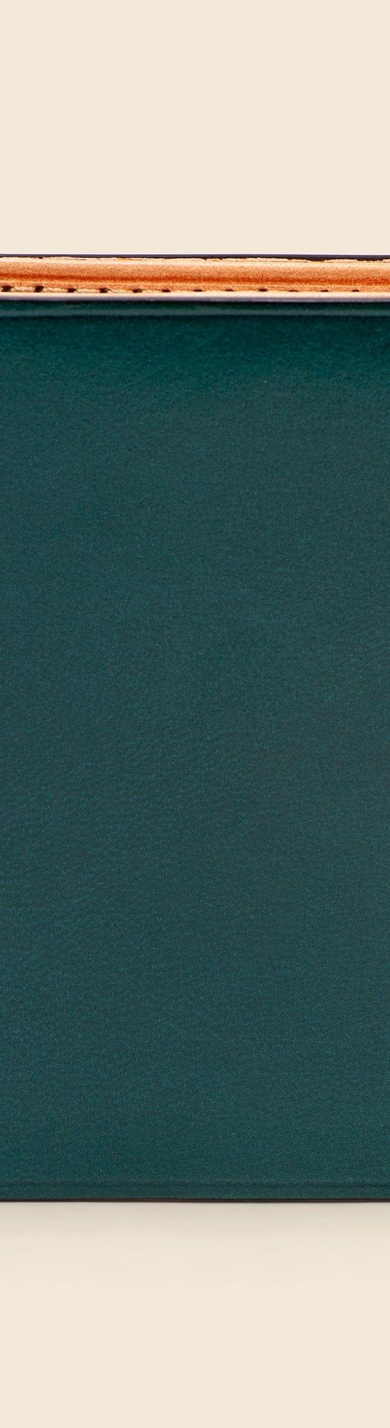 A dark green Il Bussetto hand-dyed leather bifold wallet with natural tan interior