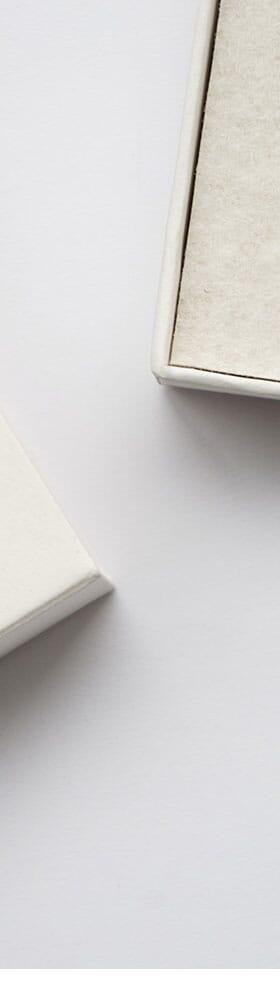 An Instrmnt watch with a white dial and slim steel case presented in its felt-lined box beside a notebook
