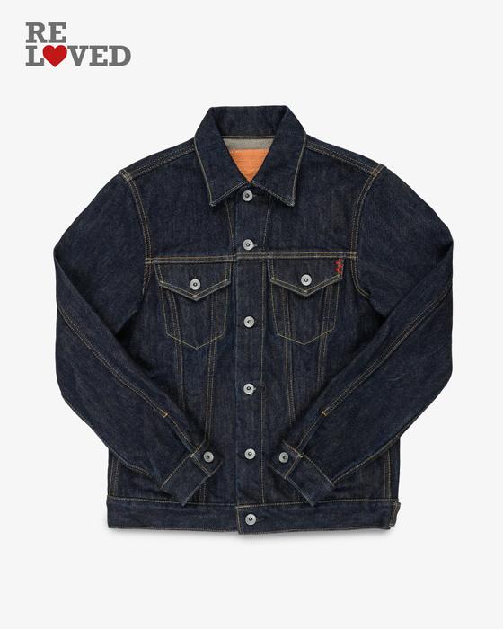 An Iron Heart indigo selvedge denim trucker jacket on a plain white background