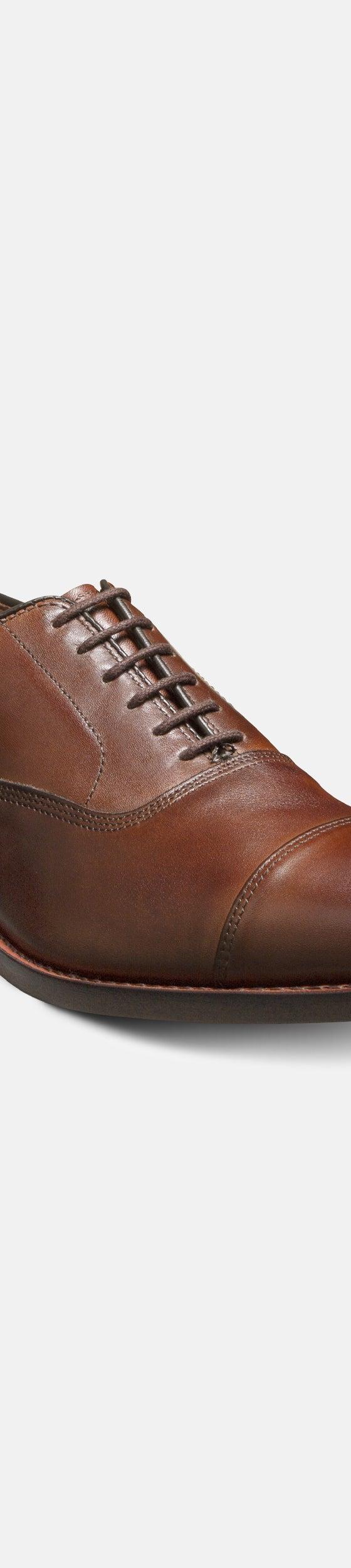 A brown leather cap-toe oxford shoe from J. Press Pennant Label