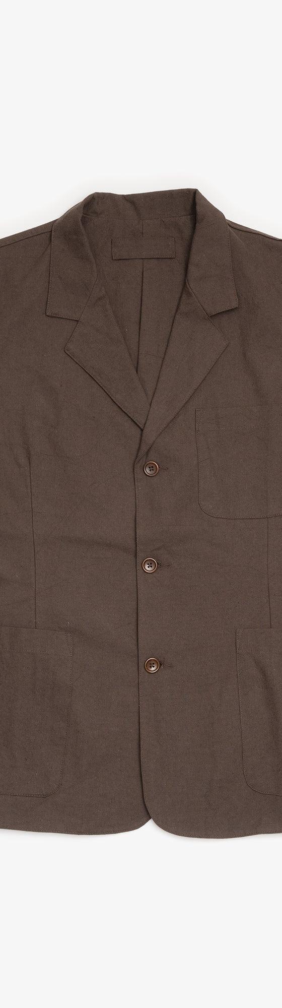A brown James Coward workwear blazer with patch pockets on a plain background