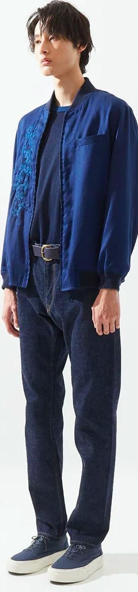 A man wearing an indigo Japan Blue bomber jacket over a navy tee with dark selvedge denim jeans