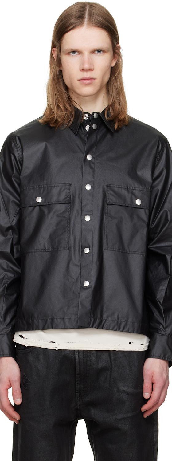 A man wearing a black coated cotton overshirt with snap-front closure