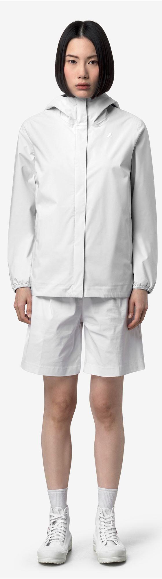 A woman wearing a white K-Way hooded windbreaker jacket with matching shorts