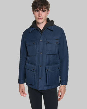 A man wearing a navy Karl Lagerfeld Paris four-pocket field jacket with black trousers