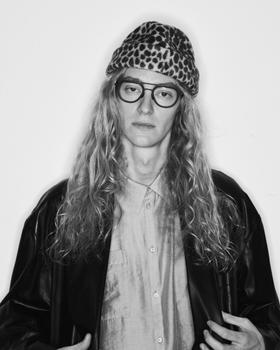 A man wearing a leopard-print KIJIMA TAKAYUKI beanie