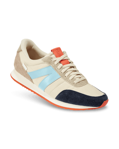A cream and navy Kizik retro runner sneaker with a light blue stripe and orange sole accents