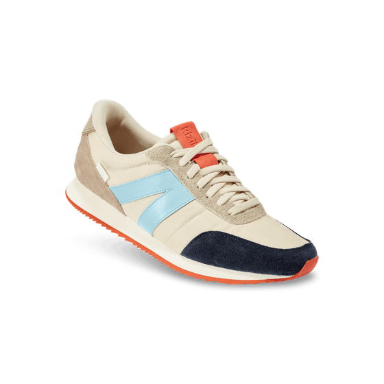 A cream and navy Kizik retro runner sneaker with a light blue stripe and orange sole accents