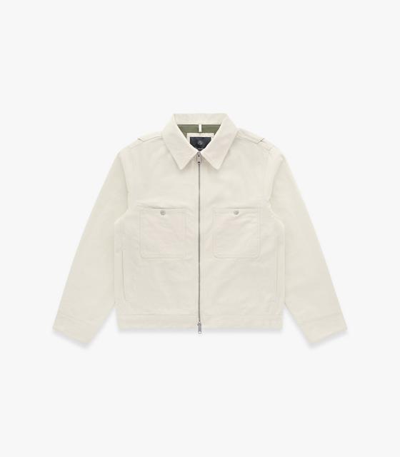 An off-white Knickerbocker zip-front work jacket with flap chest pockets on a plain background