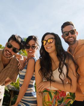Four friends wearing Knockaround polarized sunglasses outdoors in the sun