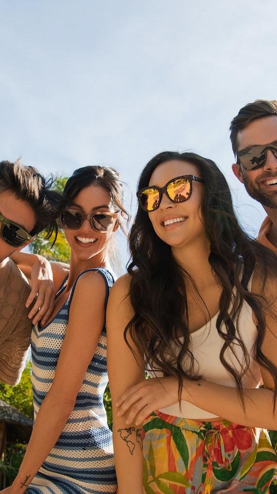 Four friends wearing Knockaround polarized sunglasses outdoors in the sun