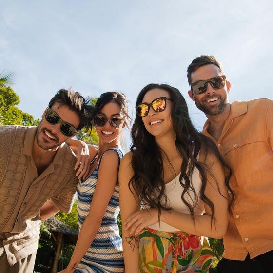 Four friends wearing Knockaround polarized sunglasses outdoors in the sun