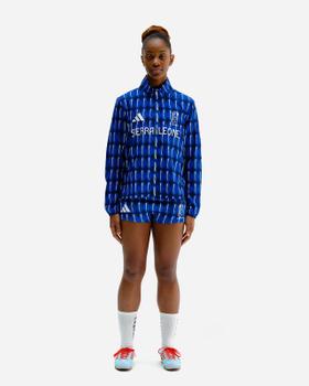 A woman wearing a blue patterned Labrum London tracksuit jacket and shorts