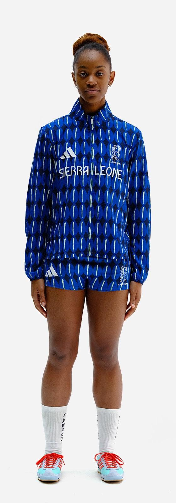 A woman wearing a blue patterned Labrum London tracksuit jacket and shorts