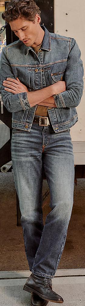A man wearing a Lee denim trucker jacket and straight-leg jeans
