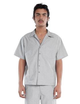 A man wearing a grey Les Tien short-sleeve camp collar shirt and matching trousers