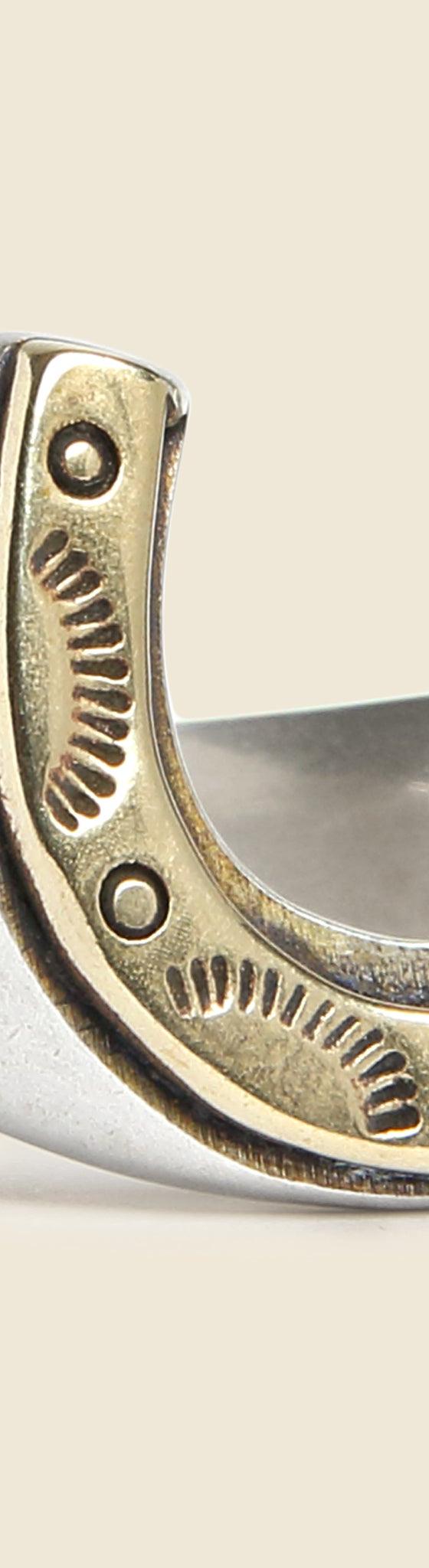 A silver and brass horseshoe signet ring by LHN Jewelry