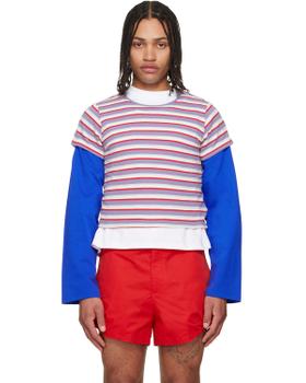 A man wearing a striped LII layered top with blue sleeves and red shorts