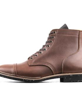 A brown leather Luosjiet cap-toe service boot with a Goodyear welt and speckled black sole