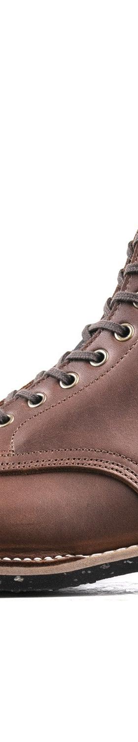 A brown leather Luosjiet cap-toe service boot with a Goodyear welt and speckled black sole