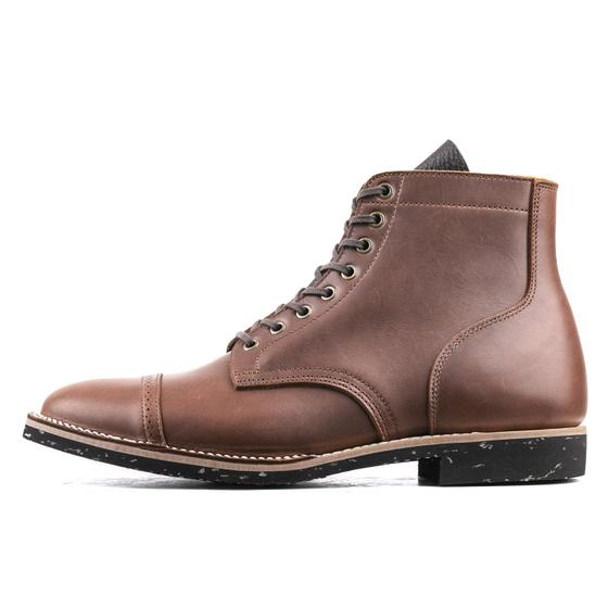 A brown leather Luosjiet cap-toe service boot with a Goodyear welt and speckled black sole