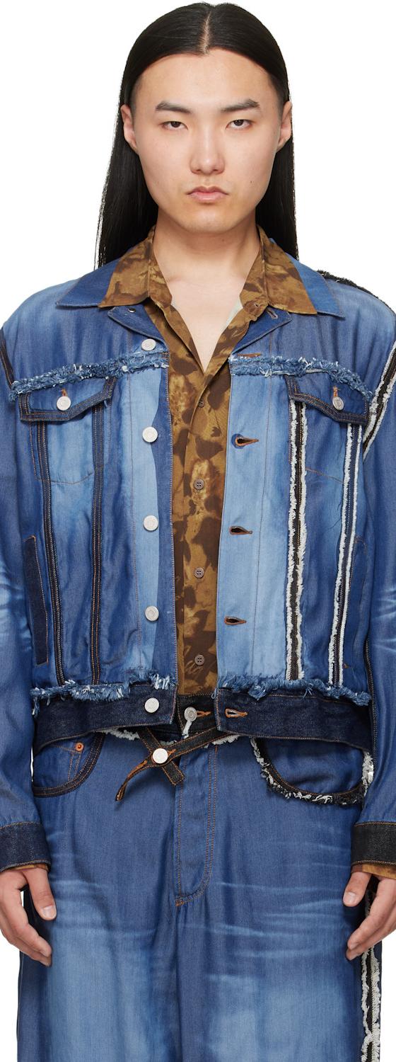 A man wearing a patchwork blue denim Magliano jacket with a printed brown shirt and matching jeans