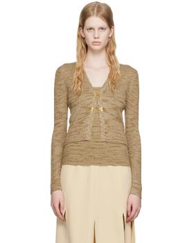 A woman wearing a beige marled knit cardigan and matching camisole with a cream slit skirt by Maiden Name