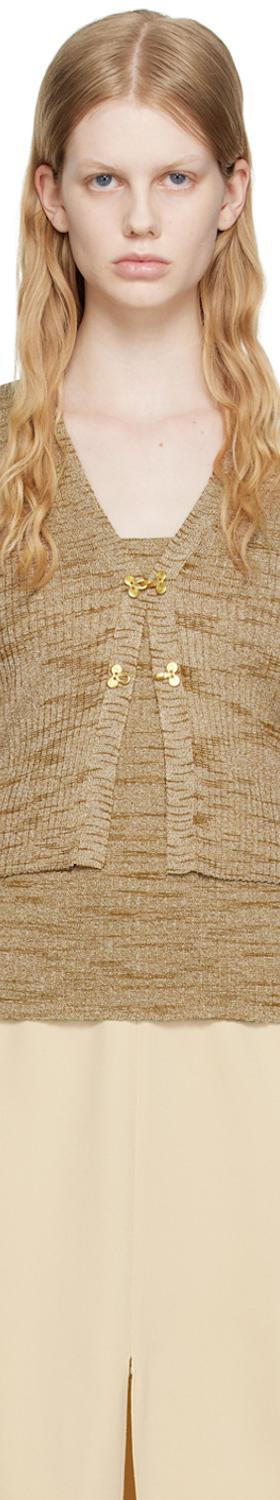 A woman wearing a beige marled knit cardigan and matching camisole with a cream slit skirt by Maiden Name