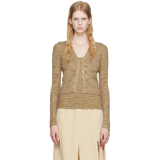 A woman wearing a beige marled knit cardigan and matching camisole with a cream slit skirt by Maiden Name