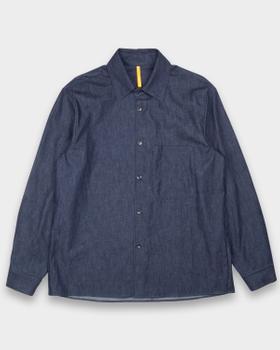 A dark indigo MAN-TLE button-up shirt with a chest pocket, shown on a plain light grey background