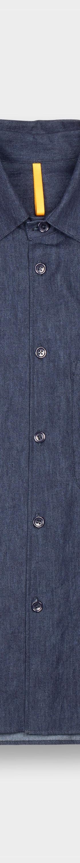 A dark indigo MAN-TLE button-up shirt with a chest pocket, shown on a plain light grey background
