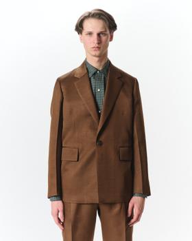 A man wearing a brown MARKAWARE tailored jacket over a green check shirt