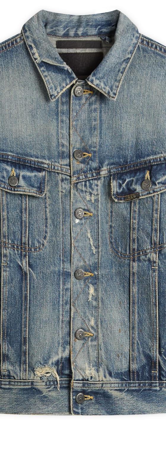 A faded blue Mastercraft Union selvedge denim trucker jacket on a plain white background