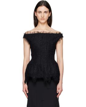 A woman wearing a black off-shoulder tulle-trimmed Matières Fécales top with a black skirt