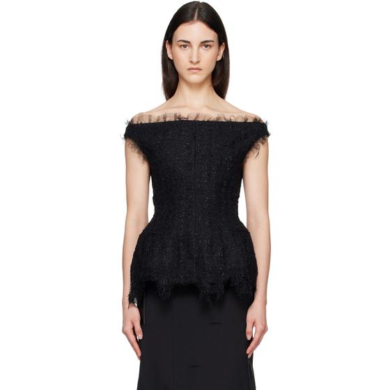 A woman wearing a black off-shoulder tulle-trimmed Matières Fécales top with a black skirt
