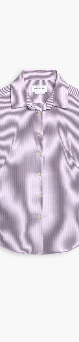 A striped Ministry of Supply performance dress shirt on a plain white background