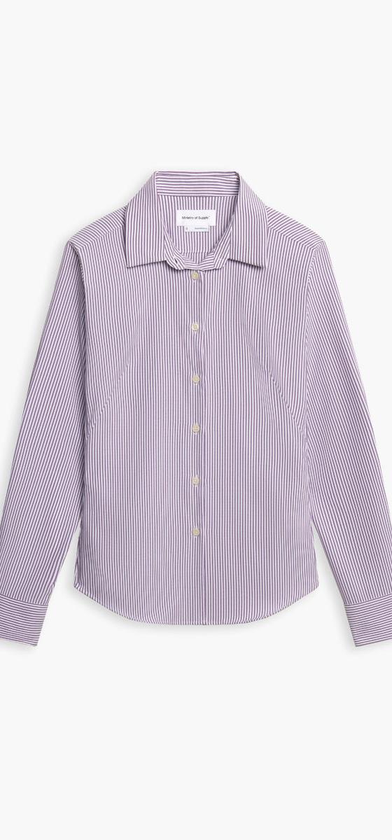 A striped Ministry of Supply performance dress shirt on a plain white background