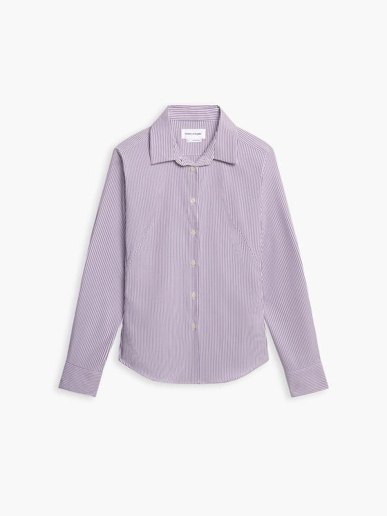 A striped Ministry of Supply performance dress shirt on a plain white background