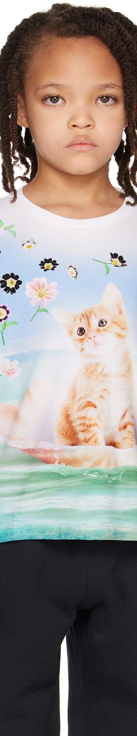 A child wearing a Molo kitten-print T-shirt with black trousers