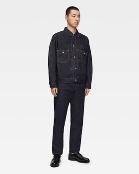 A man wearing a raw indigo Momotaro Jeans denim jacket and matching selvedge jeans