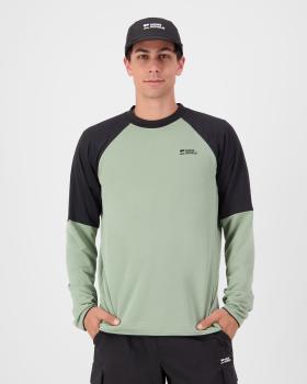 A man wearing a sage green and black Mons Royale raglan long-sleeve merino top with a black cap